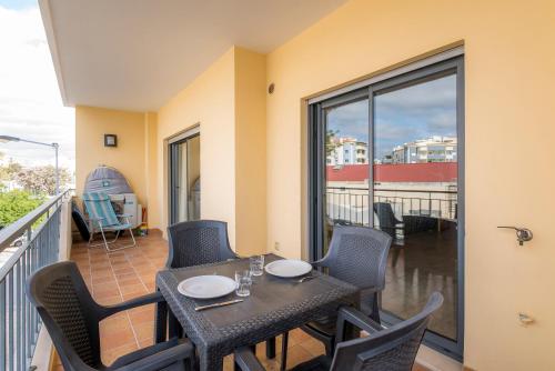 a balcony with a table and chairs on a balcony at Lagos Central Wellness in Lagos