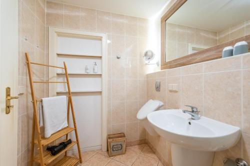 a bathroom with a sink and a mirror at Villa Stranddistel Whg.1 in Binz