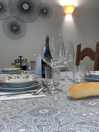 a table with wine glasses and plates on it at Borgo La Morra in Pavullo nel Frignano