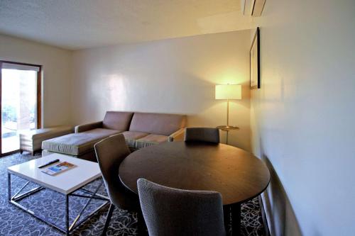 
a living room filled with furniture and a table at El Sendero Inn, Ascend Hotel Collection in Santa Fe
