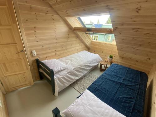 a small room with a bed and a window at 2bedroom house in Mērsrags