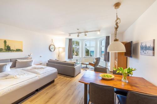 a living room with a couch and a table at Villa Glückspilz by Schewe in Binz