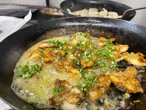 a pan of food with chicken and broccoli in it at La Tablée Médiévale in Civrieux-dʼAzergues