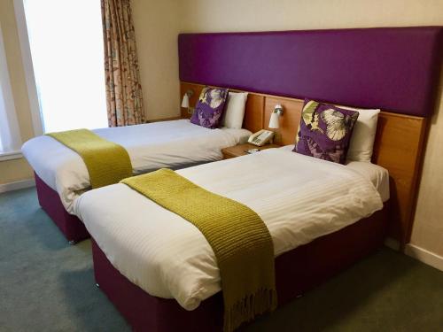 מיטה או מיטות בחדר ב-Uplawmoor