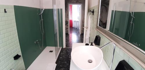 a bathroom with a toilet and a sink and a mirror at Aquarium by the Sea in Levanto