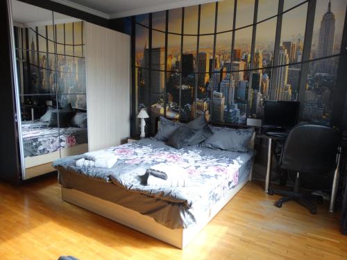 a bedroom with a bed with a view of a city at 2 Bedrooms with private Bath and balcony near the Airport in Sofia