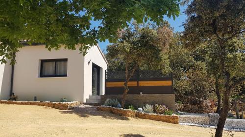 a white house with trees in front of it at gite A L' ÉVIDENCE in Mornas