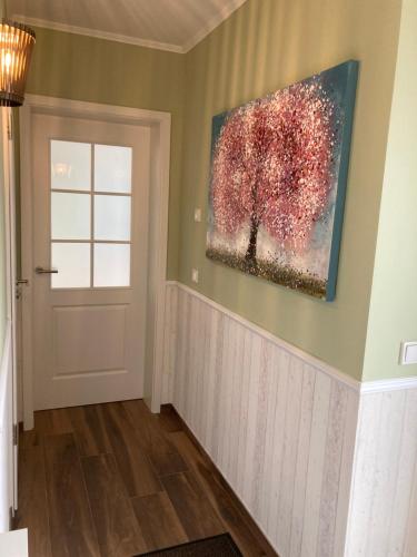 a painting of a tree on a wall next to a door at Timeout Lodges - Luxus für Zwei in Dudeldorf