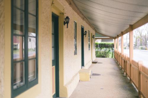 an empty hallway of a building with windows at Goat Square House - Historic Row Cottages in Tanunda
