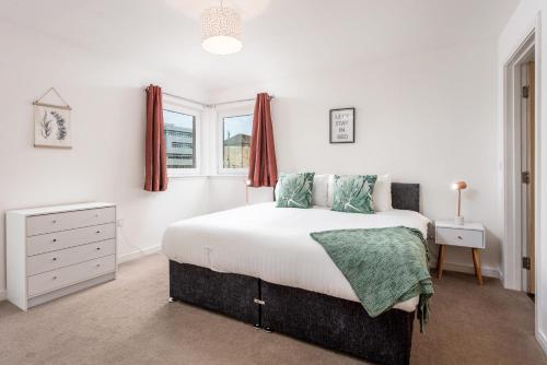 a white bedroom with a bed and a window at Walker Suite No52 - Donnini Apartments in Kilmarnock
