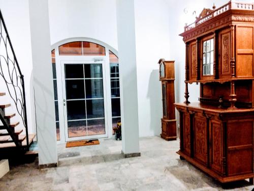 two views of a room with a dresser and a window at Dworek Akacja uslugi hotelarskie in Janowiec