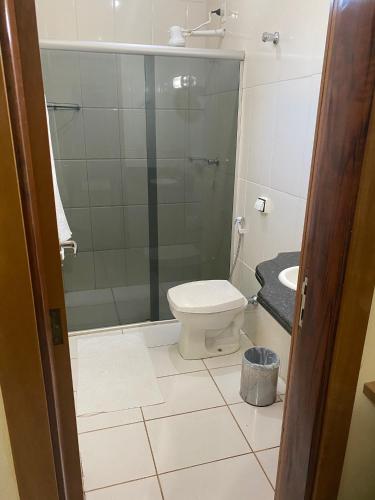 a bathroom with a shower and a toilet and a sink at Silver Lis Hotel in Acailandia