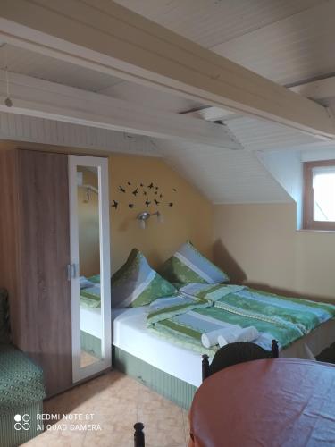a bedroom with a bed with birds on the wall at Apartmanház Gabriella in Harkány