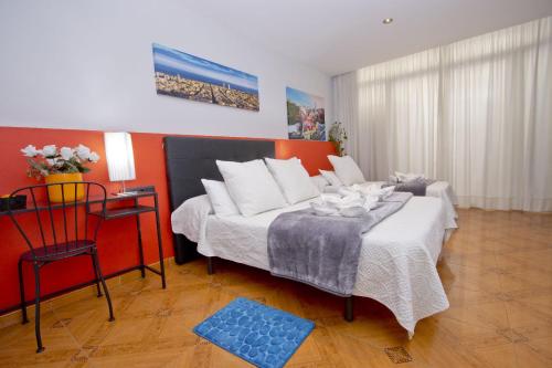 a bedroom with a bed and a table and a chair at Barcelona City Centre Hostal in Barcelona