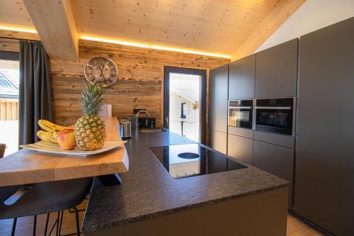 a kitchen with a table with a pineapple on a counter at Bergresort Hauser Kaibling by ALPS RESORTS in Haus im Ennstal