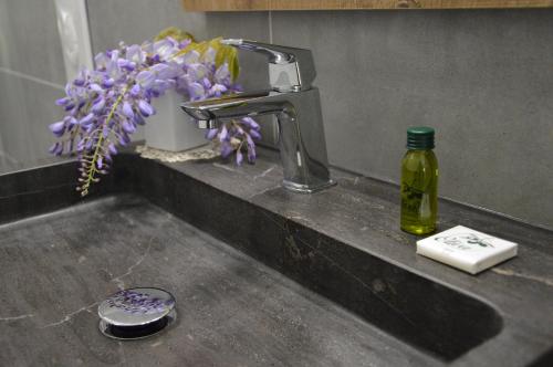 a sink with a faucet and a bottle of soap at Agriturismo Castolda in Treviglio