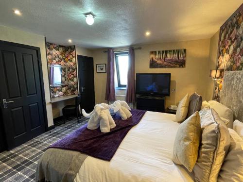 a bedroom with a bed with two elephants on it at The Albert Inn in Nairn