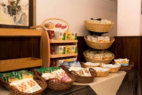 a table topped with baskets of food and snacks at Hotel California in Ariccia