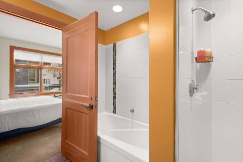 a bathroom with a tub and a shower and a sink at Capitol Peak 3312 in Aspen