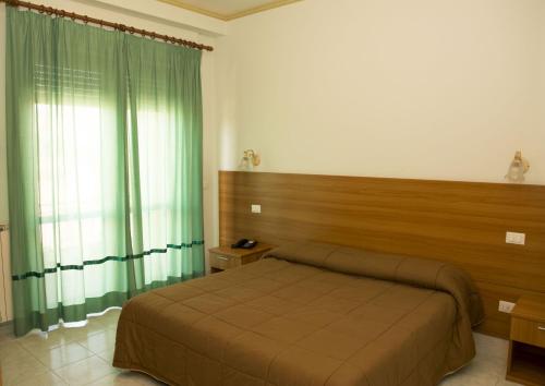 Postel nebo postele na pokoji v ubytování Hotel California