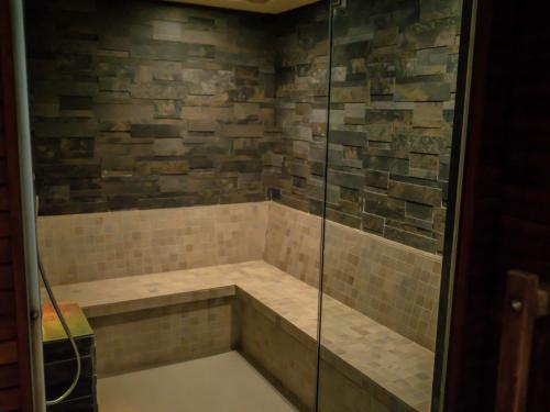 a bathroom with a shower with a bench in it at ATRIUM Sarbinowo Na Fali in Sarbinowo