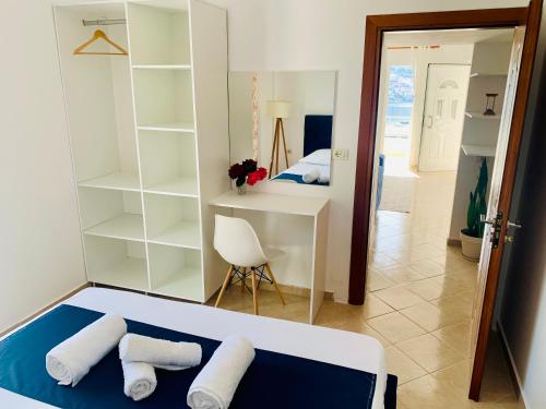 a bedroom with a bed and a desk with pillows at Villa Saral Mar in Sarandë