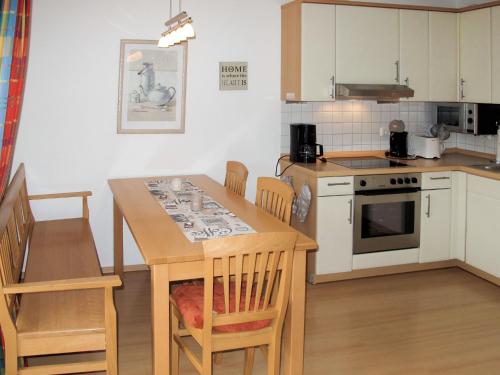 eine Küche mit Tisch und Herd oberen Backofen in der Unterkunft Apartment Stubbenkammer by Interhome in Breege