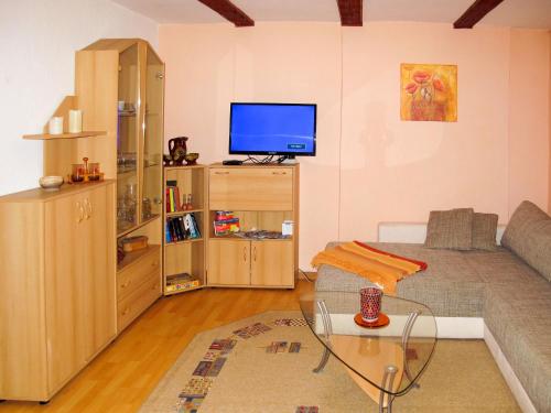 uma sala de estar com um sofá e uma televisão em Holiday Home Jana by Interhome em Buchholz