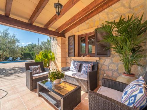 an outdoor patio with wicker chairs and a table at Holiday Home Son Catlar - INC125 by Interhome in Inca
