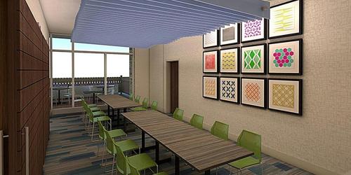 a dining room with wooden tables and green chairs at Holiday Inn Express & Suites - El Paso North by IHG in El Paso