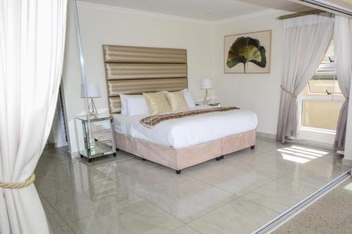 a bedroom with a large bed and a glass floor at The Holy Hill Royal Alfred Marina in Port Alfred