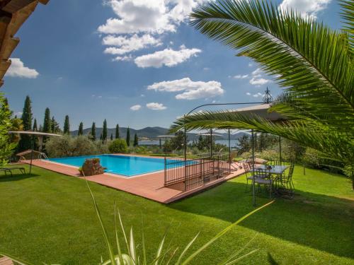 a pool in a yard with a table and chairs at Villa Olindia by Interhome in San Savino