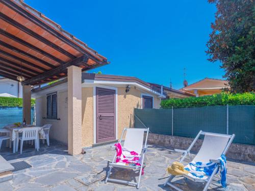 a pair of lawn chairs sitting on a patio at Holiday Home Francesca by Interhome in Marina di Pietrasanta
