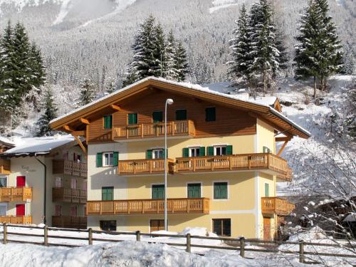 a apartment building with a balcony in the snow at Apartment Pederiva - SOF743 by Interhome in Soraga