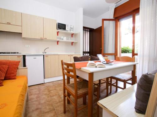 a kitchen and living room with a table and chairs at Apartment Orsa Maggiore by Interhome in Lignano Sabbiadoro