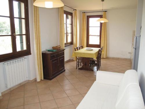 a living room with a table and a dining room at Apartment Le Macine-4 by Interhome in Cecina