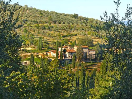 a village on a hill with trees and houses at Apartment La Romantica by Interhome in Grassina