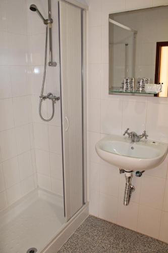 a bathroom with a sink and a shower at Hotel Porto Nobre in Porto