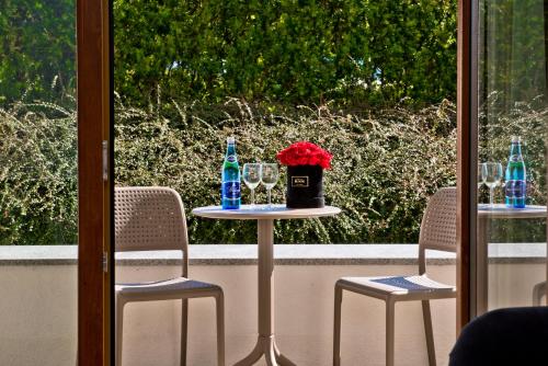 a table with two chairs and two bottles and glasses at BlueApart Apartamenty Na Klifie in Władysławowo