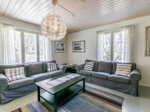 ein Wohnzimmer mit 2 Sofas und einem Kronleuchter in der Unterkunft Holiday Home Tallbacka by Interhome in Bromary