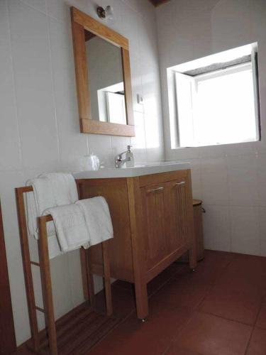 a bathroom with a sink and a mirror at QUINTA DAS FIGUEIRAS in Velas