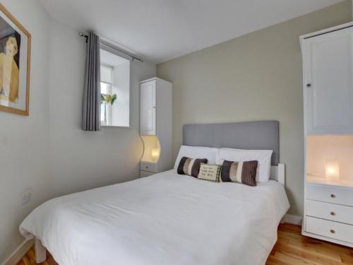 a bedroom with a white bed and a window at Apartment Belle View by Interhome in Ilfracombe