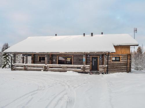 a log cabin with snow on the roof at Holiday Home Villa aurora by Interhome in Säkkilänvaara