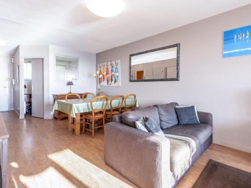 a living room with a couch and a dining room at Apartment Résidence Kerentrech-3 by Interhome in Quiberon