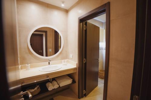 a bathroom with a sink and a mirror at AWKA Apart Hotel in Villa La Angostura