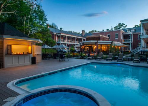 a large swimming pool with chairs and a building at Inn at Diamond Cove in Great Diamond Island