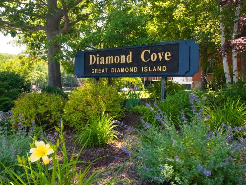 a sign for the diamond cove great diamond island in a garden at Inn at Diamond Cove in Portland