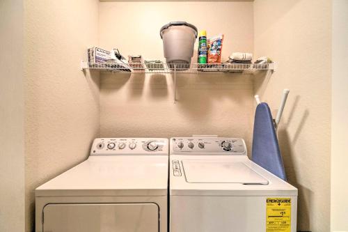 a small kitchen with a white stove and a shelf at River Strand Country Club Condo with Pool Access! in Bradenton
