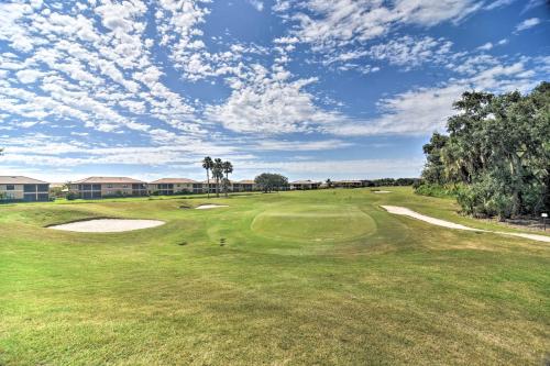 a view of a golf course with palm trees and a green at River Strand Country Club Condo with Pool Access! in Bradenton