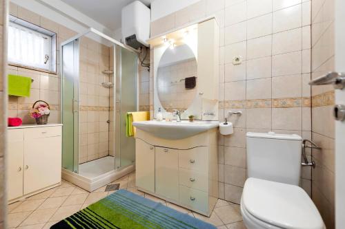a bathroom with a toilet and a sink and a shower at Apartment & Rooms Graciela in Rovinj